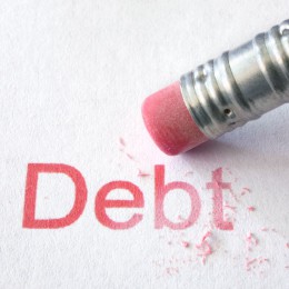 Pencil erasing the word debt