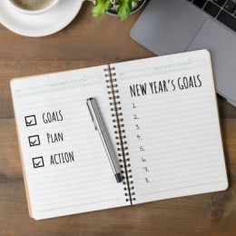 notebook stating goals plan action for the new year goals