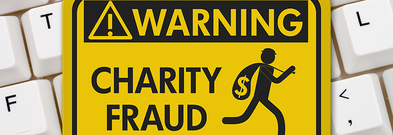 Charity Fraud sign on a keyboard