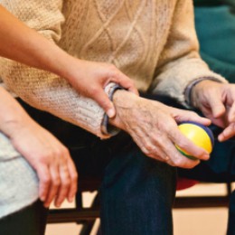 Image of a person holding the arm of an older person