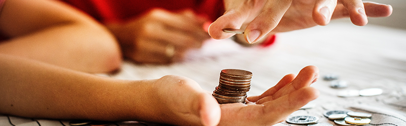 parent putting money in a kids hand